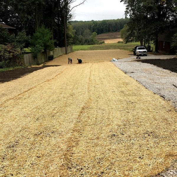 plot of land with hay atop getting ready to grow grass